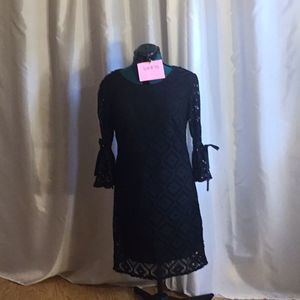 Shift style dress in black with crochet outer, belled tie sleeves in size 10